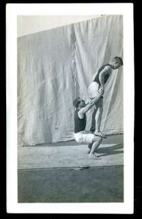 1910s PHOTO GYMNAST MAN LIFTS UP & STARES INTO PARTNERS BUTT  