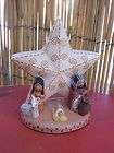 clay nativity set holy family under large star peru returns